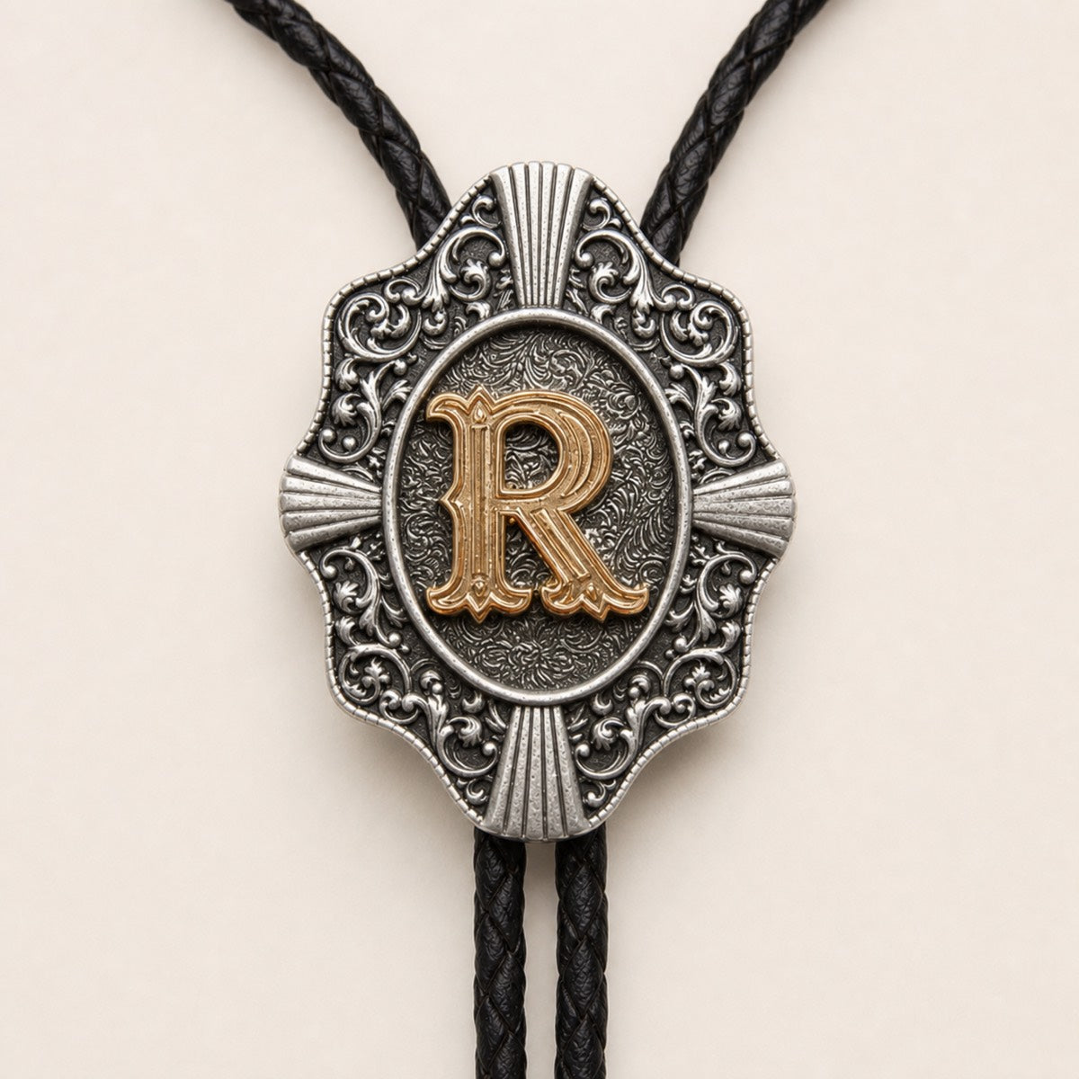 Gold letter R bolo tie engraved metal craftsmanship detail