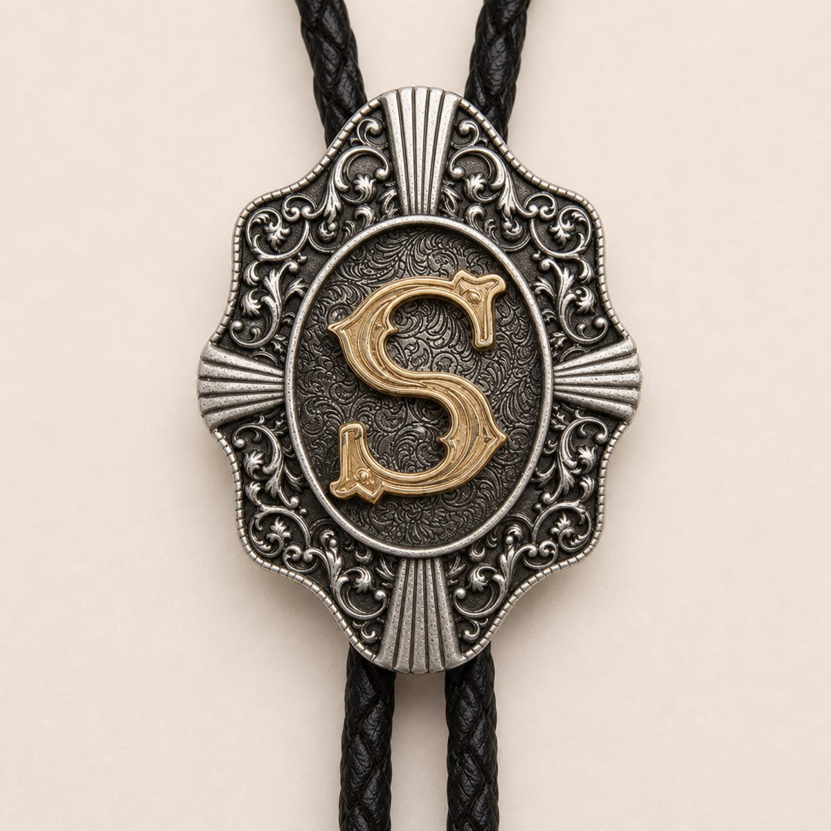 Gold letter S bolo tie engraved metal craftsmanship detail