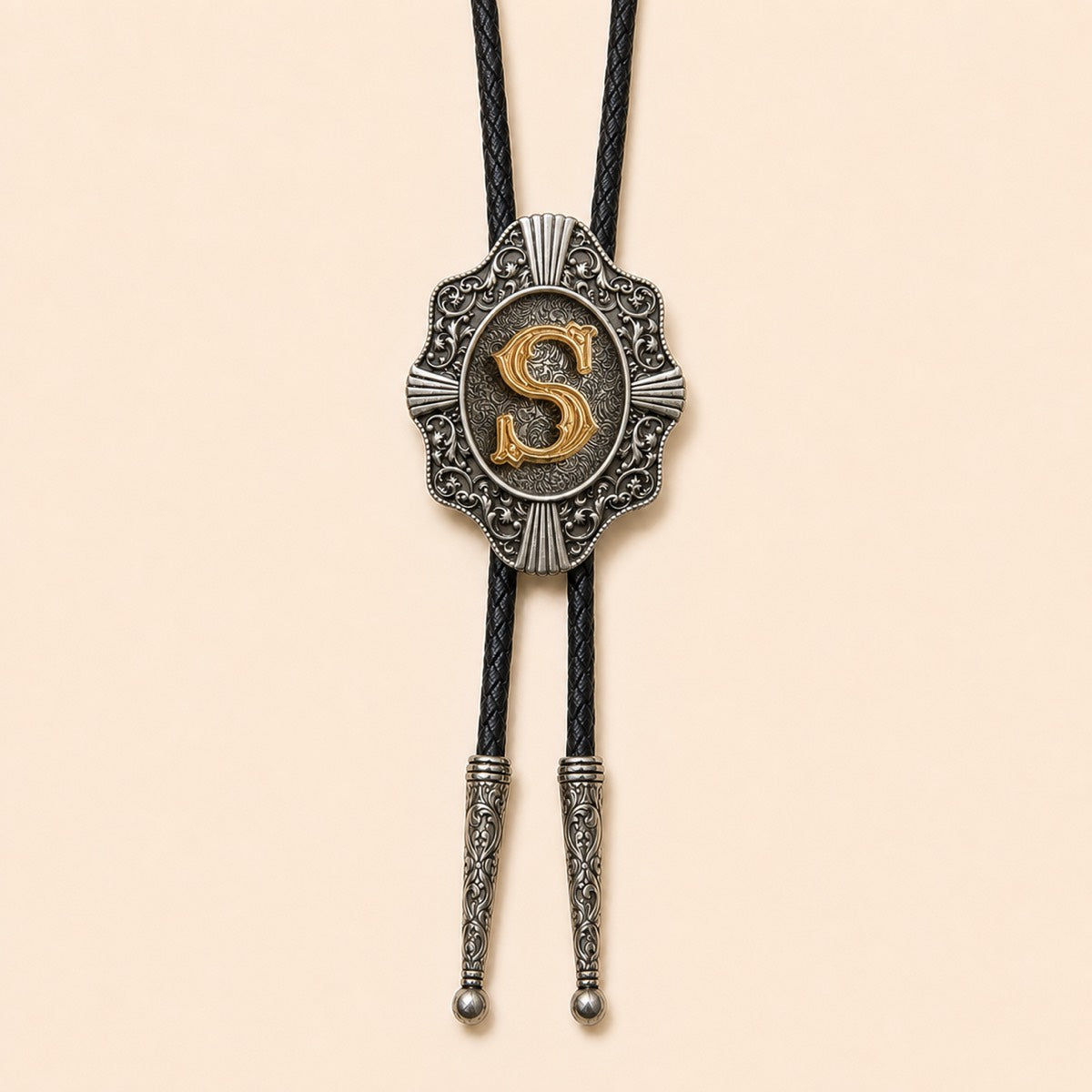 Gold letter S western bolo tie on pale warm ivory background