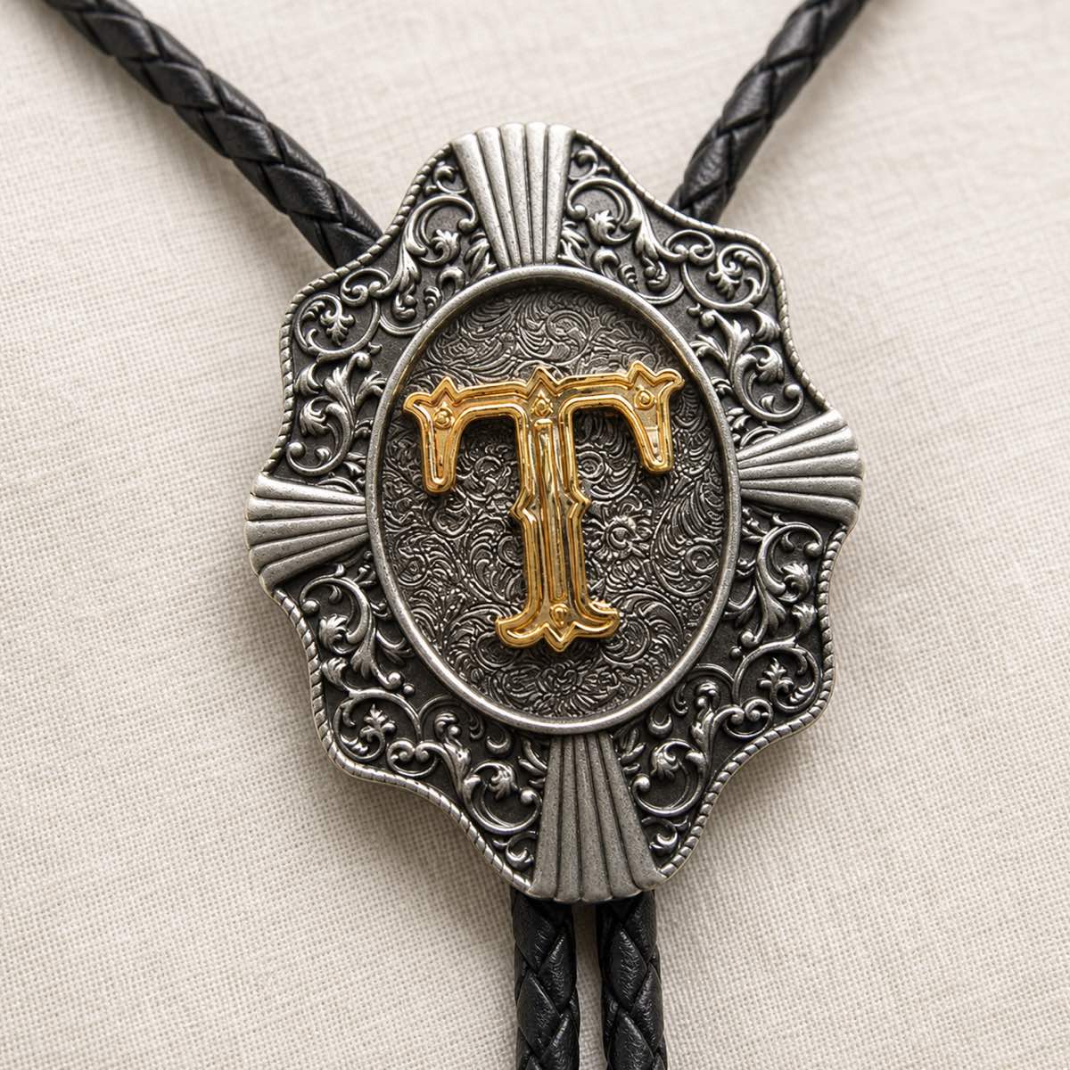 Gold letter T bolo tie antique silver engraving and leather detail