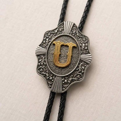 Gold letter U bolo tie antique silver engraving and leather detail