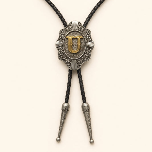 Gold letter U western bolo tie on pale warm ivory background