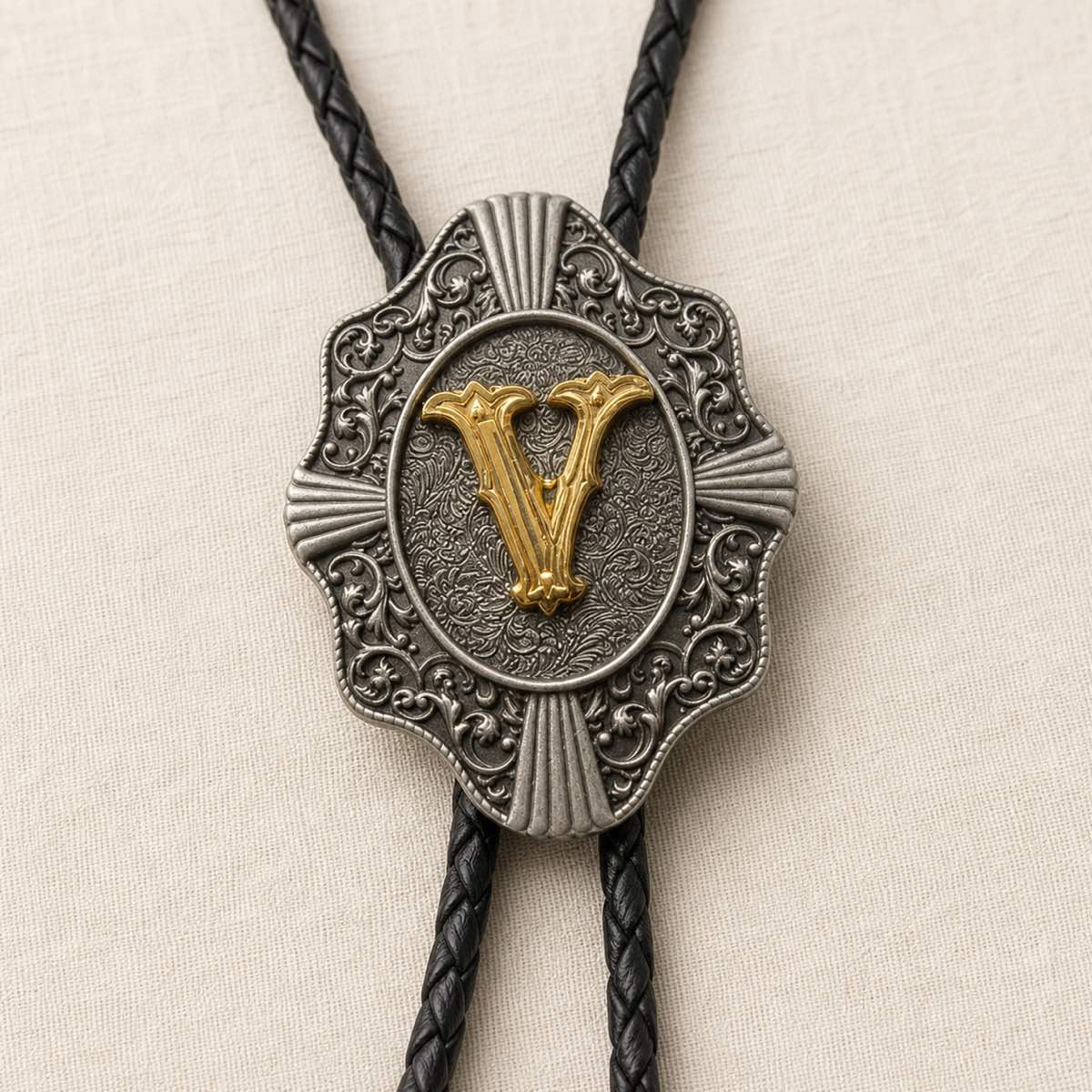 Gold letter V bolo tie antique silver engraving and leather detail