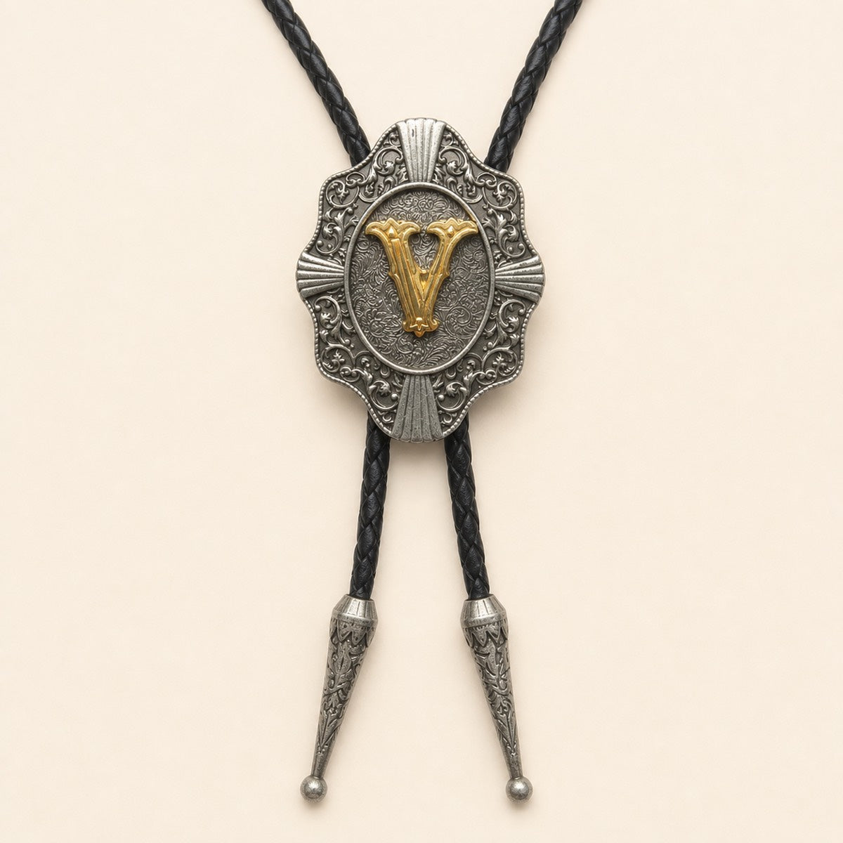 Gold letter V western bolo tie on pale warm ivory background
