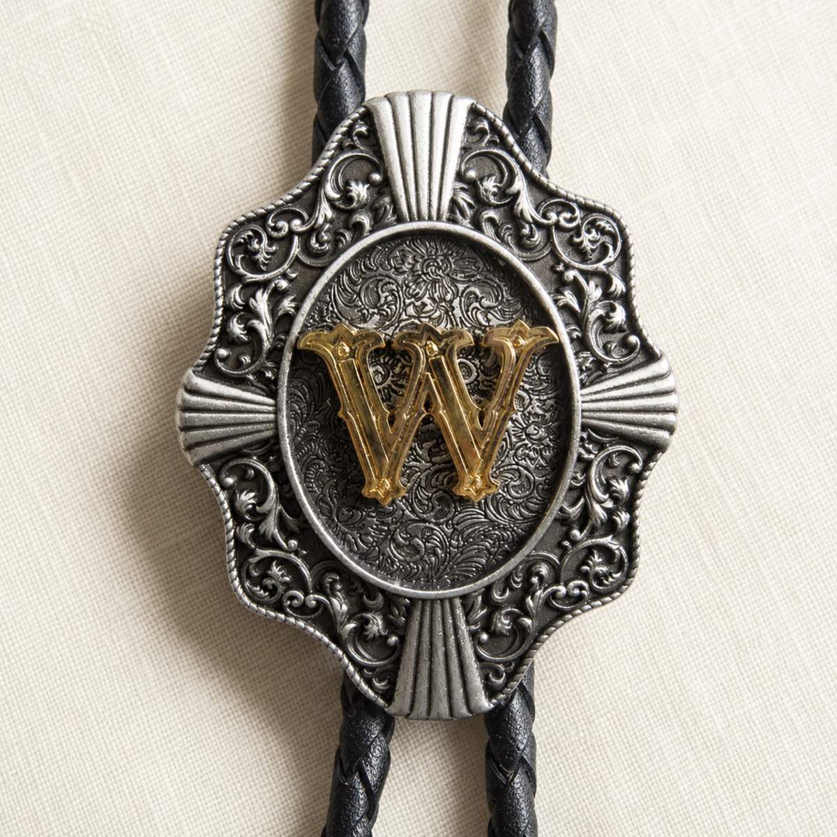 Gold letter W bolo tie antique silver engraving and leather detail