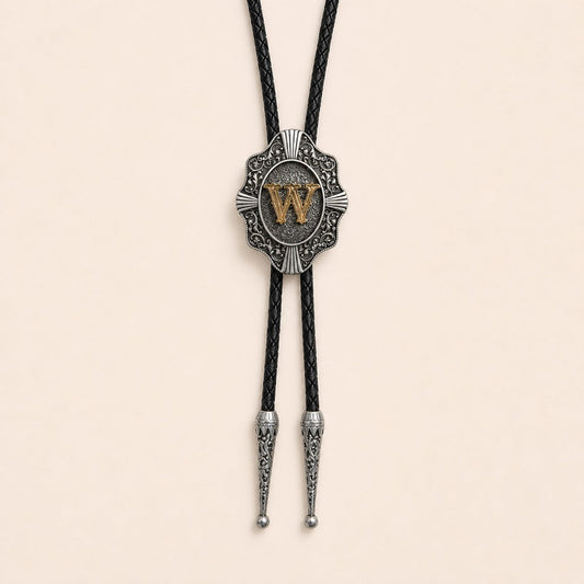 Gold letter W western bolo tie on pale warm ivory background