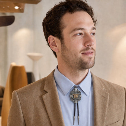 Young man wearing a true-scale gold letter W western bolo tie