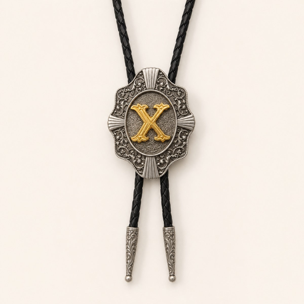 Gold letter X western bolo tie on pale warm ivory background