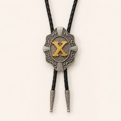 Gold letter X western bolo tie on pale warm ivory background