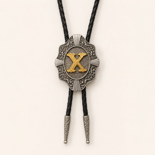 Gold letter X western bolo tie on pale warm ivory background