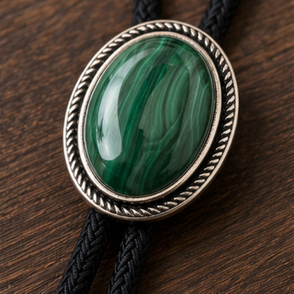 Close-up detail of natural green malachite stone and antique silver-tone bolo tie frame